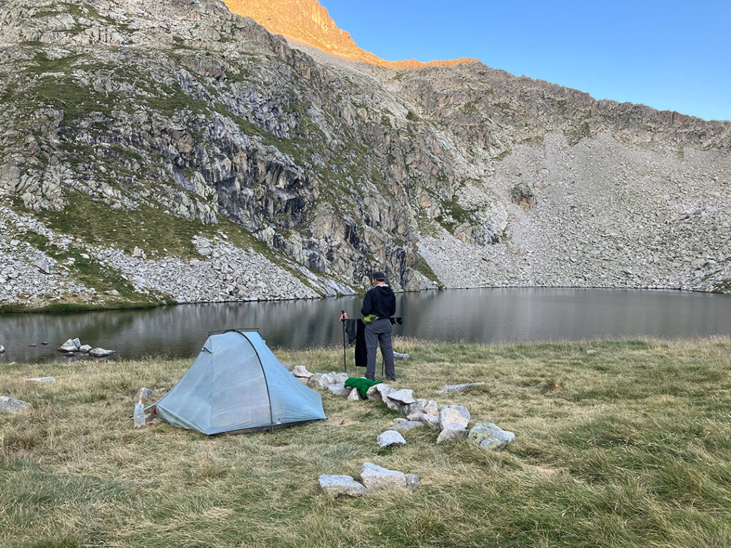 Christer is hanging newly washed clothes to dry, by the tent and lake