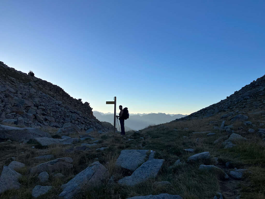 Christer standing infront of an amazing early morning view with several mountains layers behind him.