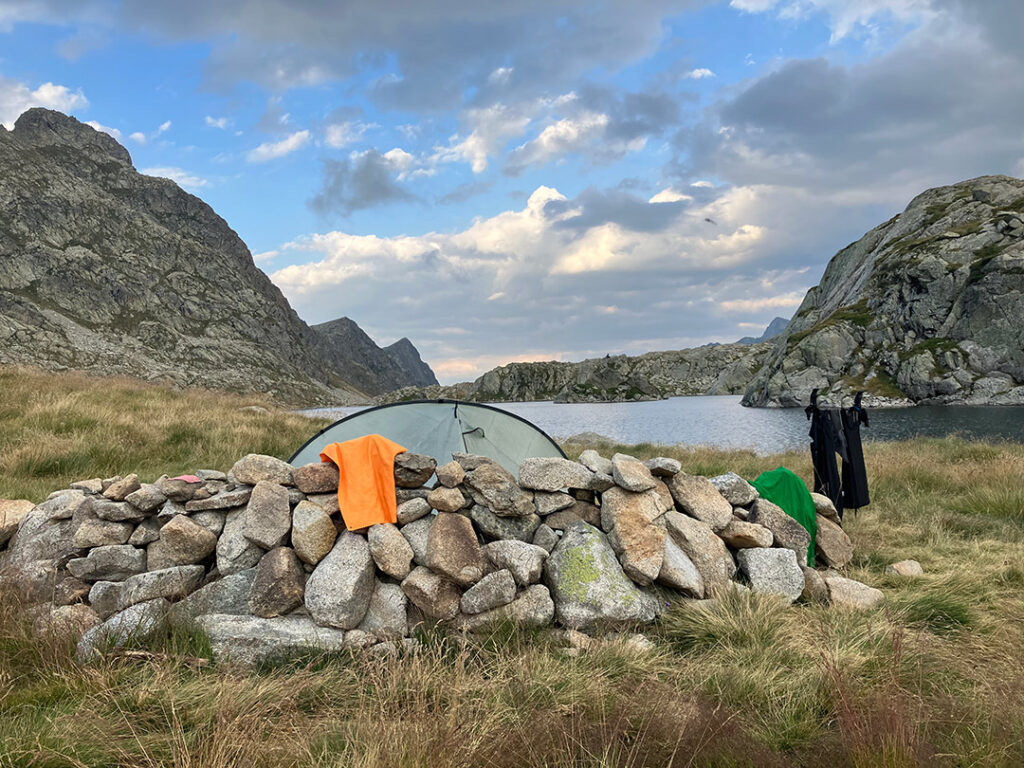 Tent by a lake, clothes hanging to dry