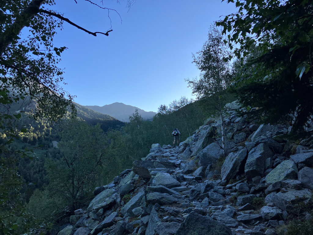 Early morning, Bert walking on a stoney path in the mountains